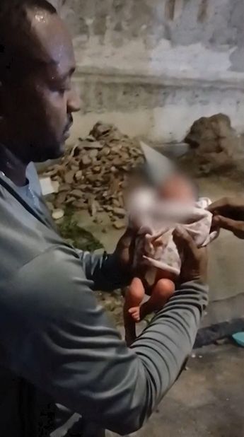Mmento cuando el hombre localiza a la bebé entre la basura en Río de Janeiro/ AFP