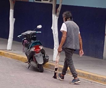 Hombre camina por calles de Santa María Coapan, Tehuacán, con un lomito desollado y sin órganos / Cortesía Apolonia Amayo